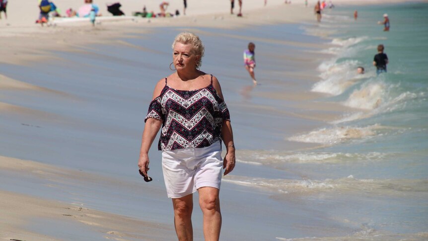 Robyn Hudson walking along Mullaloo Beach, where a memorial was held for her son Wade Dunn