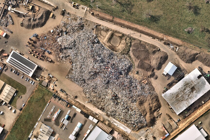 A satellite view of mounds of shredded metal in a yard.