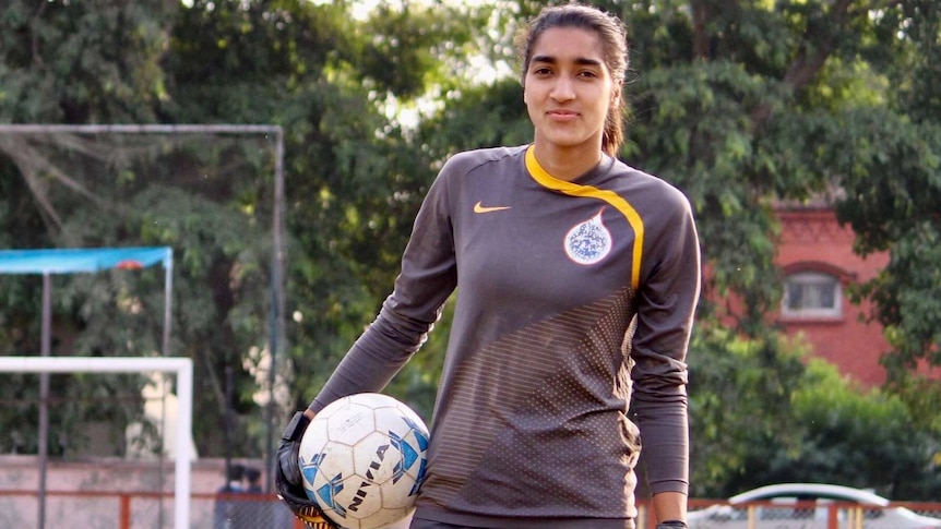 Afshan Ashiq holds a ball