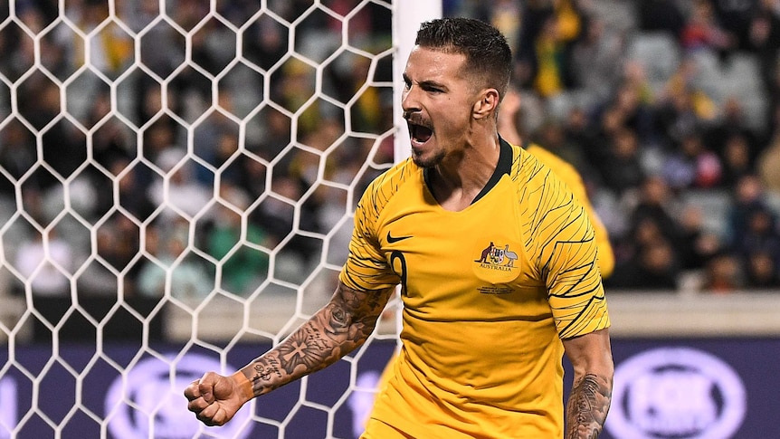 Jamie Maclaren celebrates by screaming and clenching his fists