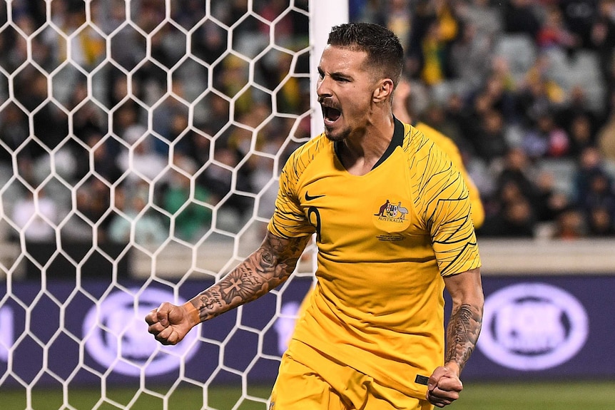 Jamie Maclaren celebrates by screaming and clenching his fists