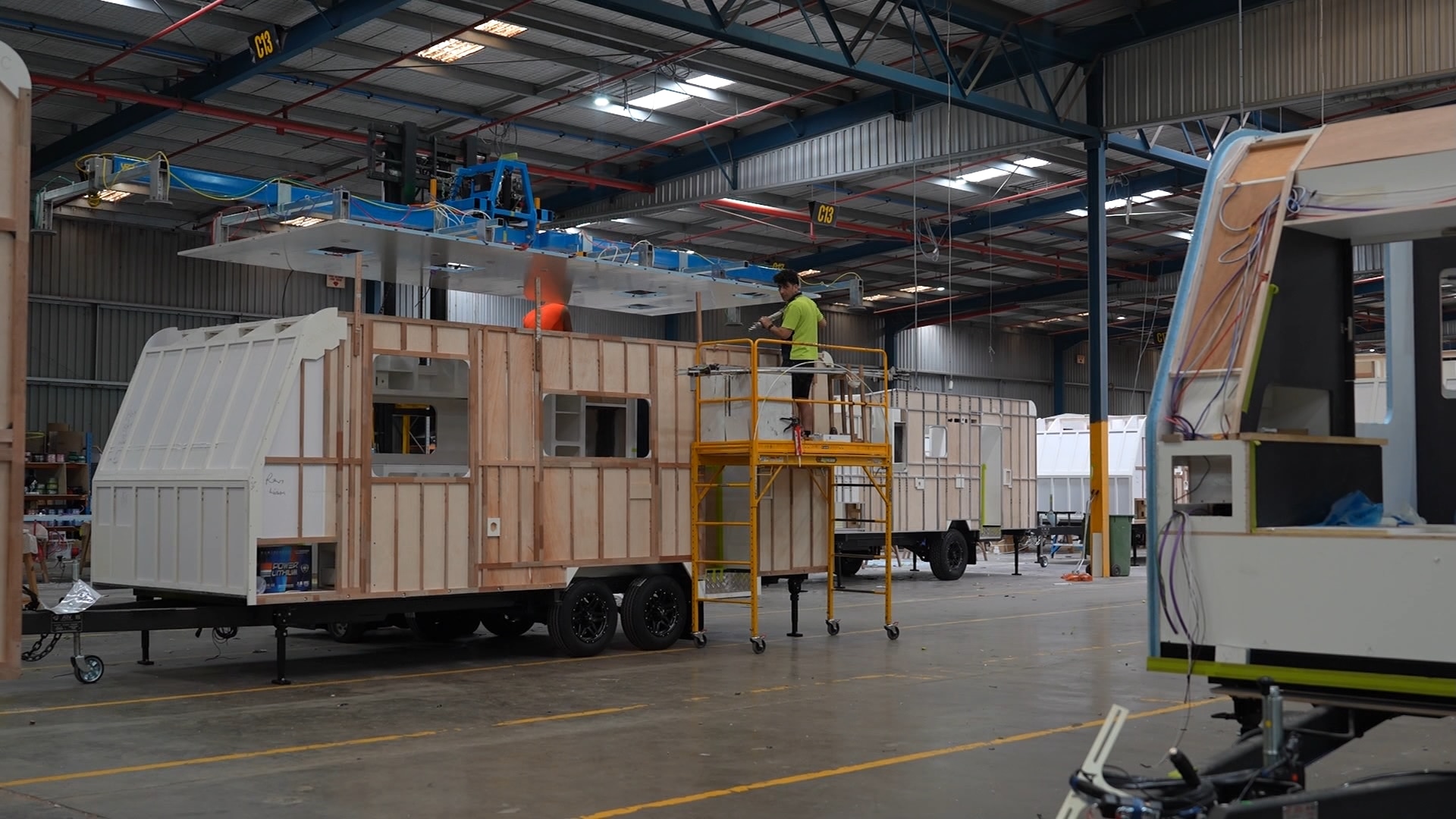 A caravan being manufactured on a factory floor.