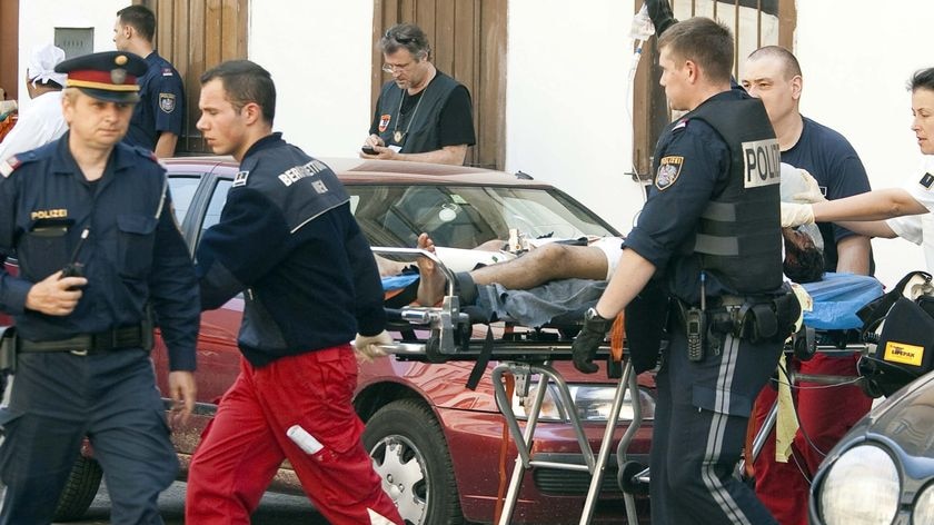An injured person is transported out of a Sikh temple in Vienna