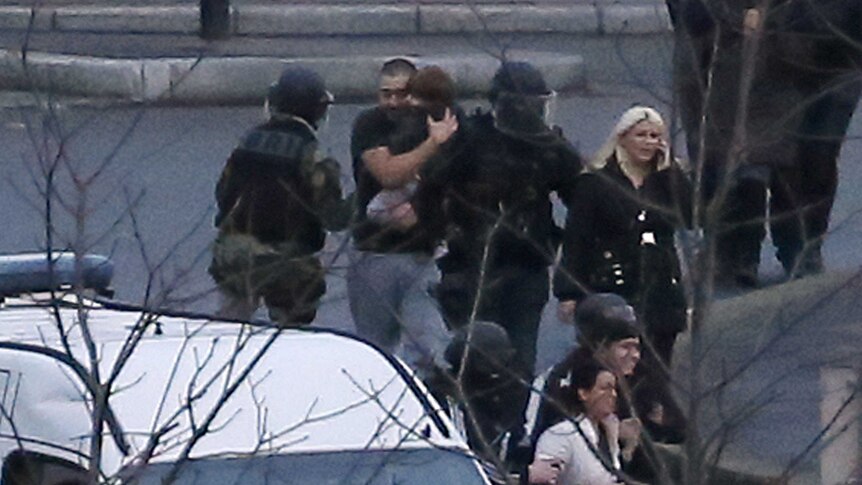 French police special forces evacuate hostages including a child
