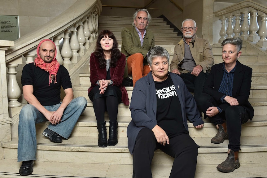 Group shot of the authors sitting on a staircase.