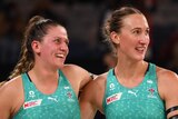 Two Melbourne Vixens Super Netball players embrace as they celebrate beating Sunshine Coast Lightning.