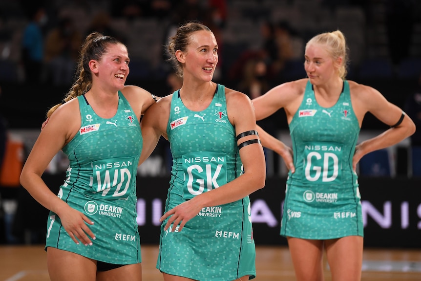 Two Melbourne Vixens Super Netball players embrace as they celebrate beating Sunshine Coast Lightning.