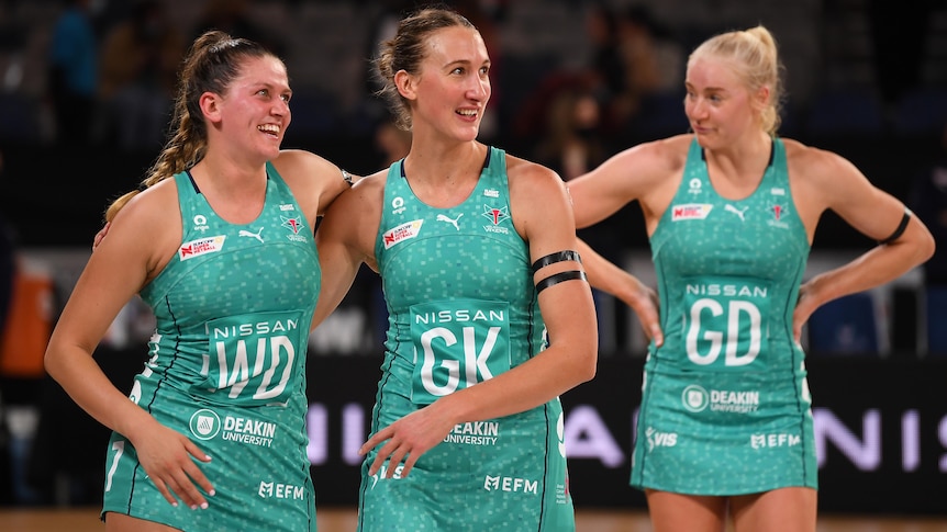 Two Melbourne Vixens Super Netball players embrace as they celebrate beating Sunshine Coast Lightning.