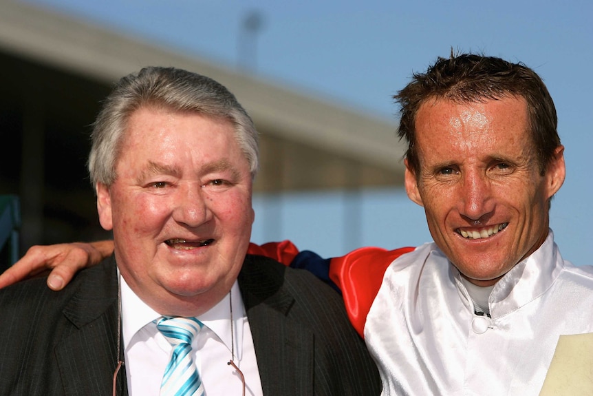 Roy Higgins alongside Damien Oliver