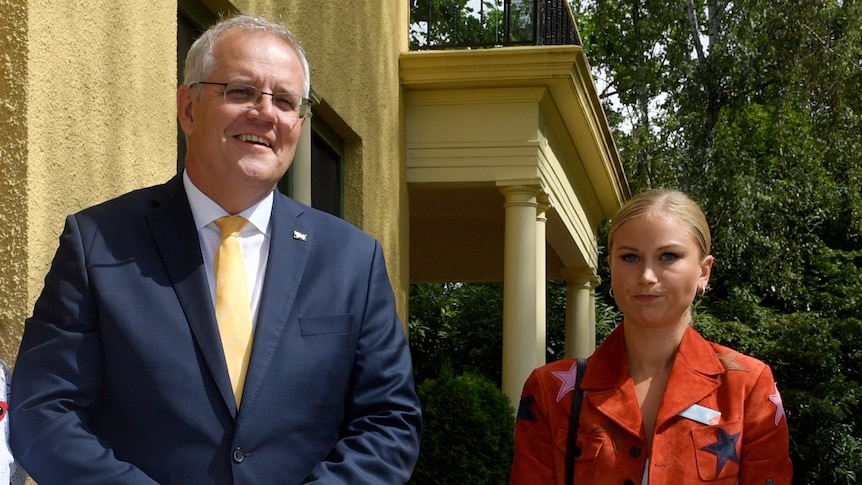 Prime Minister Scott Morrison stands next to Grace Tame outside a building.