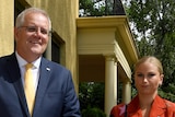 Prime Minister Scott Morrison stands next to Grace Tame outside a building.