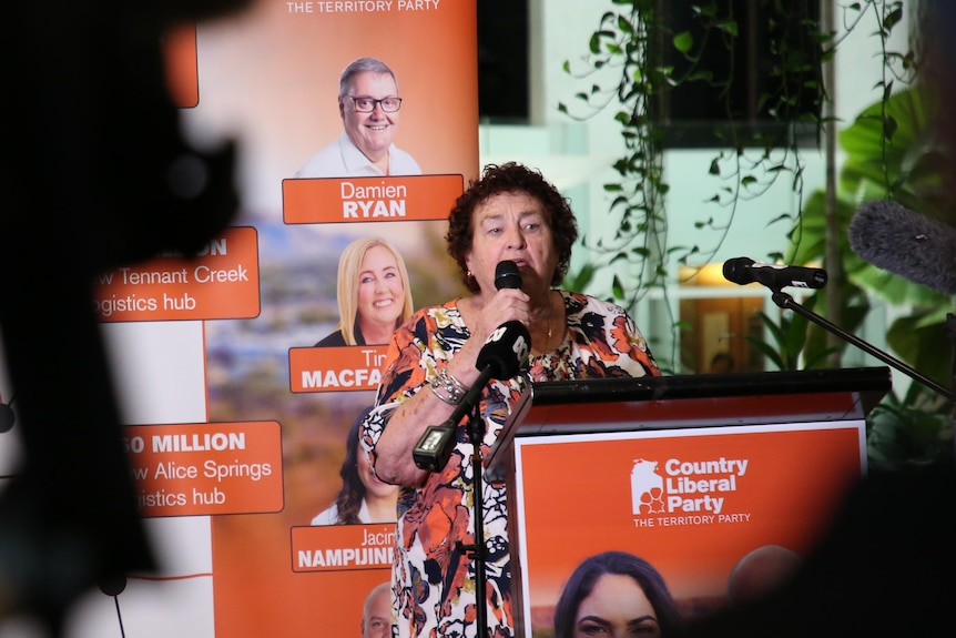 woman at podium talking into microphone. 