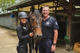 Hannah Guise and Senior Sergeant Paul Mason stand next to horse Stormy.