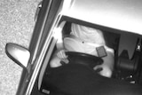 Man used mobile phone while driving in black and white image taken by new camera.