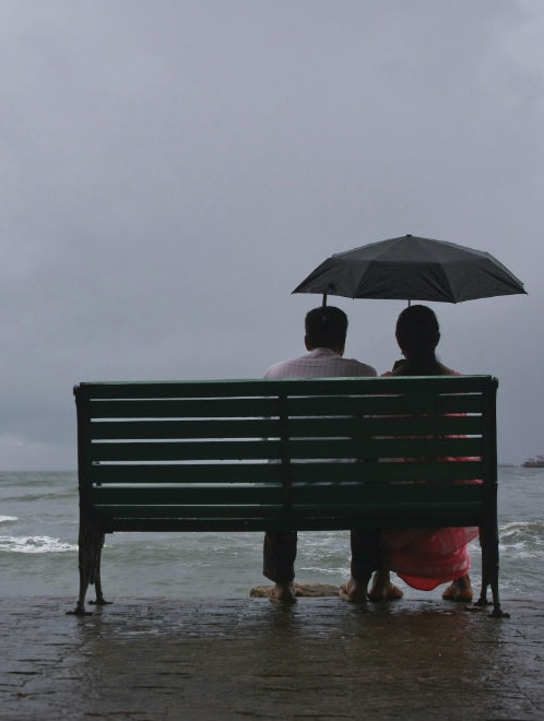 Kerala couple sitting on a bench India