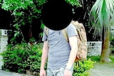The blurred face of a man in camouflage.