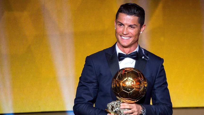 Top gong ... Cristiano Ronaldo shows off the 2014 FIFA Ballon d'Or award in Zurich