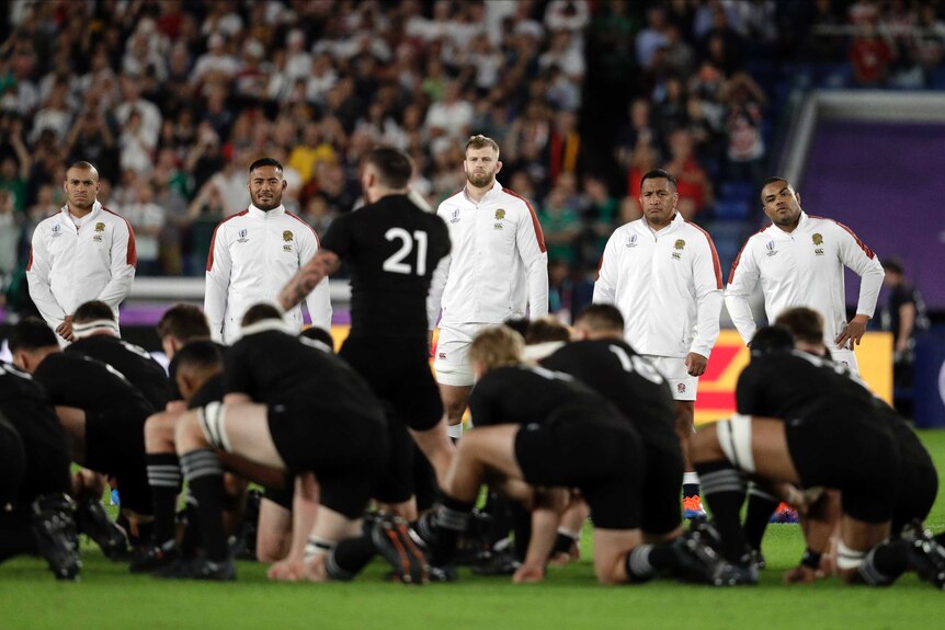 England players watch as New Zealand players perform Haka before their Rugby World Cup semi-final.