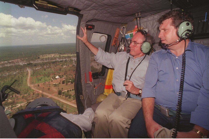 Then prime minister John Howard and then chief minister Shane Stone survey Katherine from a helicopter.