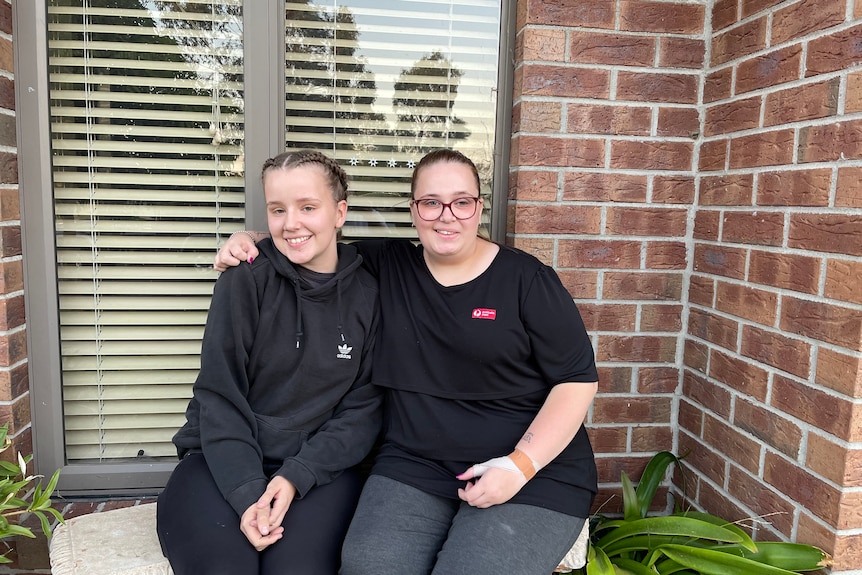 Britt and Jordyn Knight sit side-by-side, smiling at the camera.