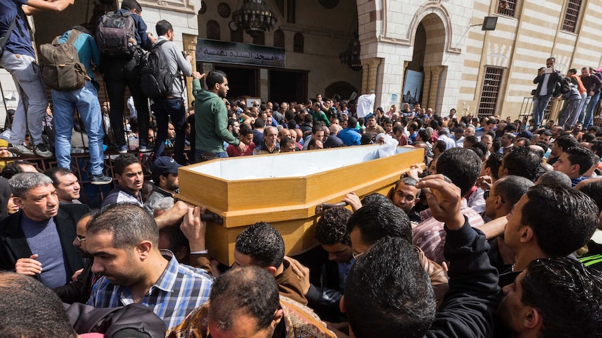 Mourners carrying the coffin of Mohamed Sayed at his funeral