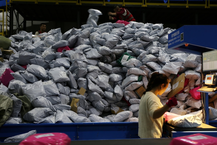 Employees sort parcels at a logistics base on the Singles' Day online shopping festival