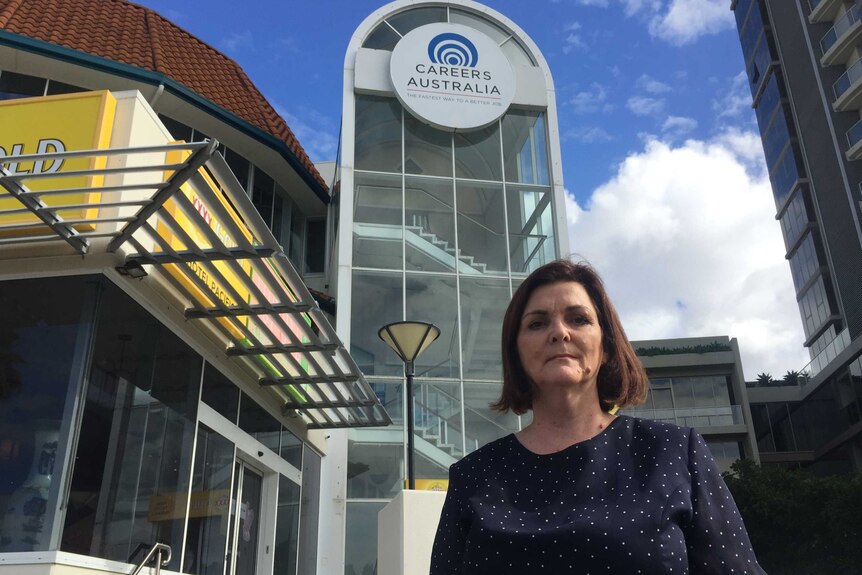 Former Careers Australia staff member, Roslyn Bennett, stands in front of the Careers Australia office on the Gold Coast
