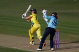 Alyssa Healy looks up in the air after playing a flick shot off her pads, with Taylor the keeper behind her.