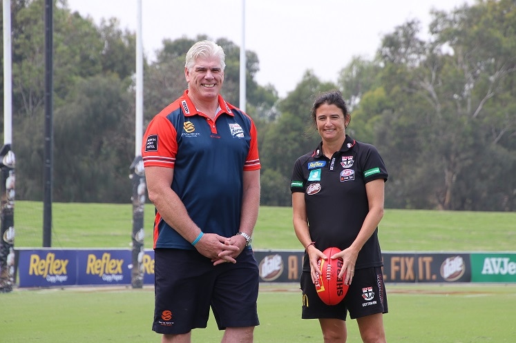 Gary Ayres and Peta Searle stands next to each other.