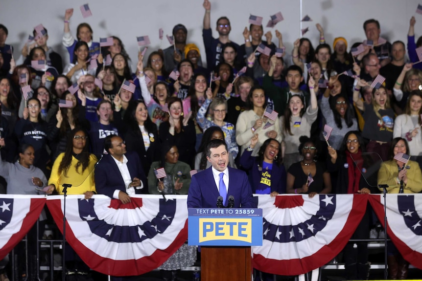 Pete Buttigieg stands in front of a crowd