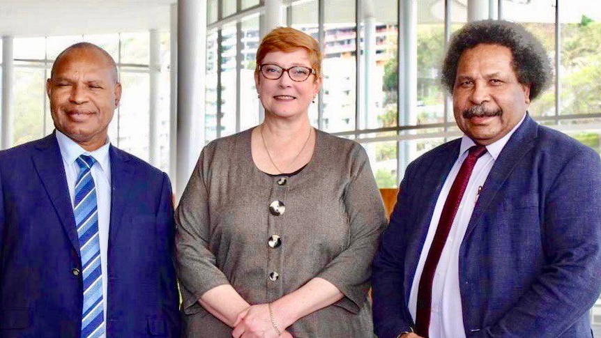 Marise Payne stands with PNG Government ministers Richard Maru and Soroi Marepo Eoe in Port Moresby.