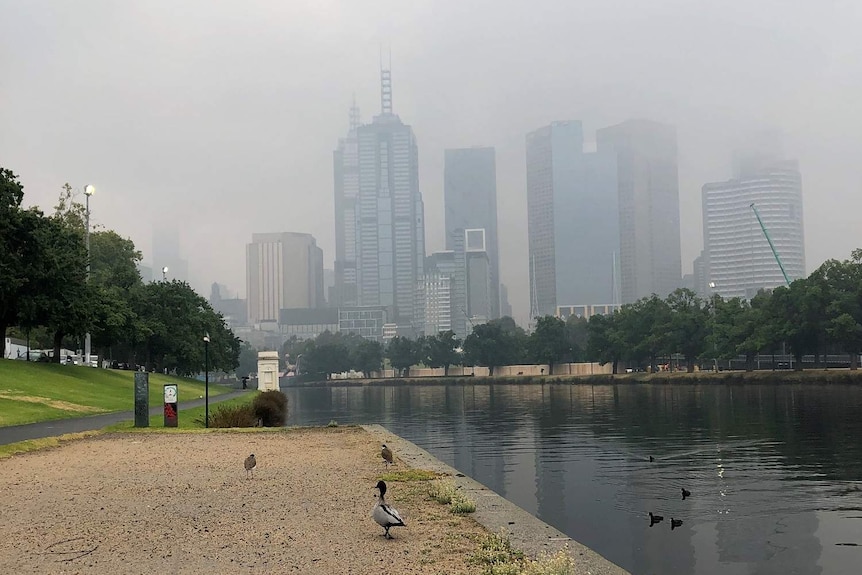 The Yarra River and Melbourne skyline which is shrouded in a thick haze.