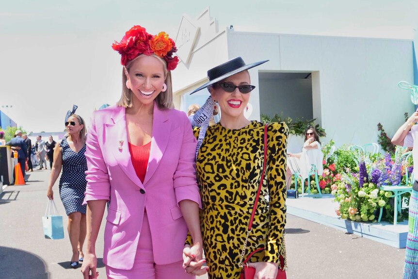 Two brightly dressed racegoers at the Flemington Racecourse.