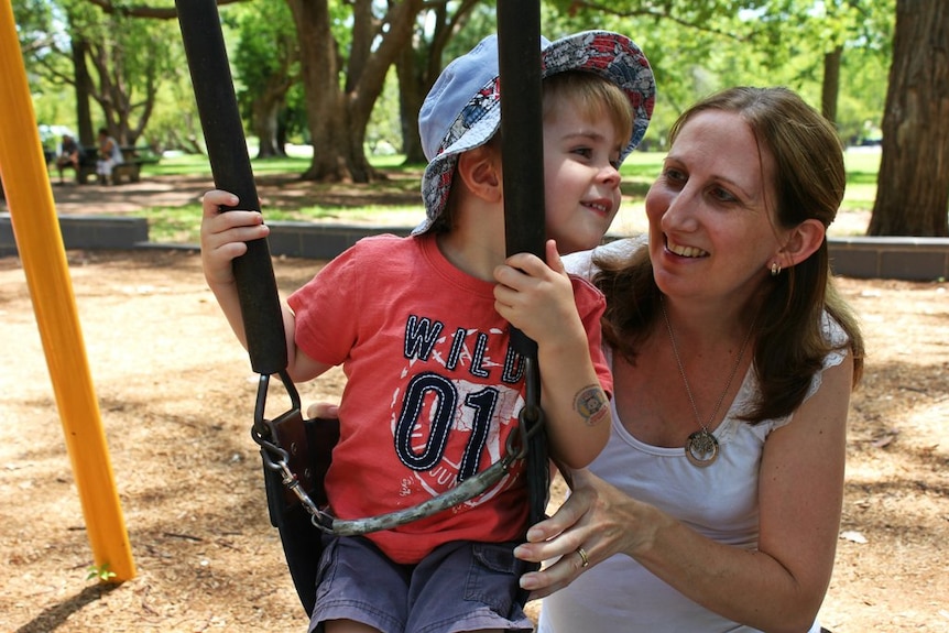 Dana Stephens pushes her two-year-old son Lachlan on a swing