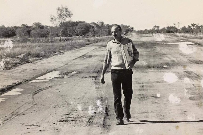 A black and white photo of a younger Warren Snowdon walking down a road.