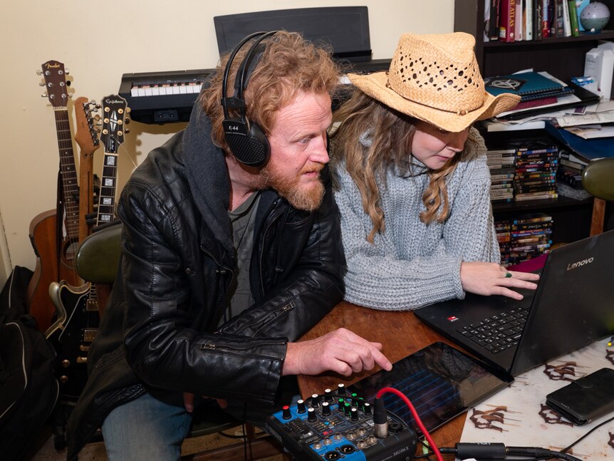 Lockdown music show director Andrew Deasey and host Emma Almen with computer equipment.