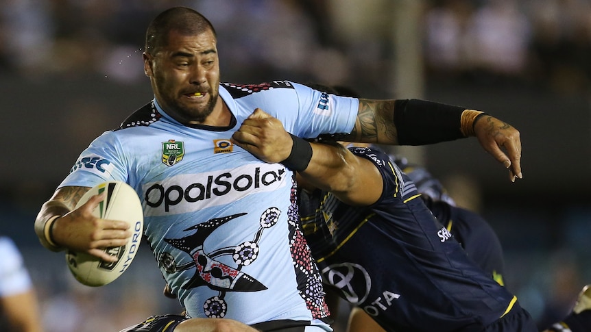 Andrew Fifita is tackled by the Cowboys