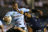 Andrew Fifita is tackled by the Cowboys