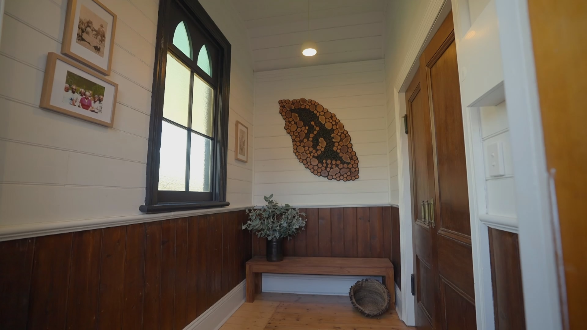 The entryway of a house with images and artwork on the walls.