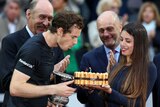 Andy Murray blows out the candle on his birthday cake after winning the Rome Masters final.