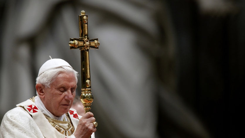 Pope Benedict XVI holds the crucifix in Saint Peter's Basilica