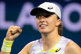 A Polish female tennis player pumps her left fist at the Miami Open.