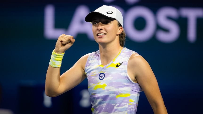 A Polish female tennis player pumps her left fist at the Miami Open.