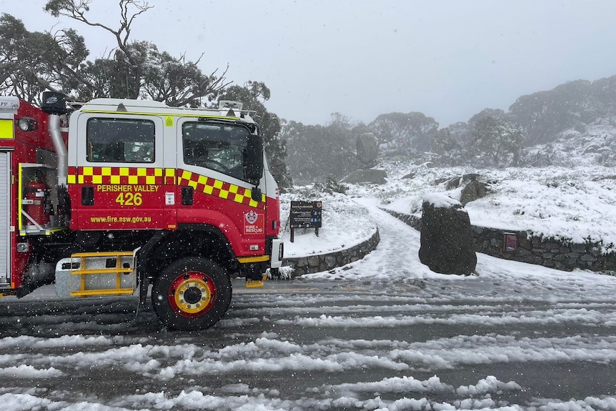 fire truck against white mountain covered in snow 