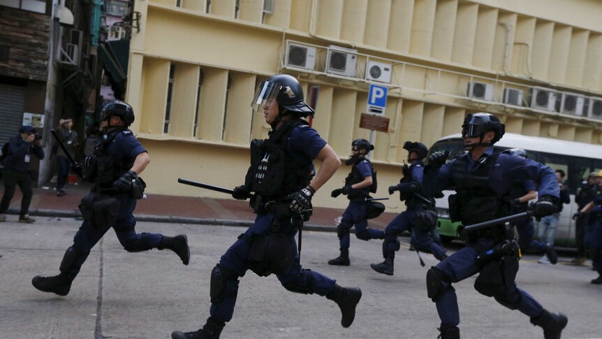 Hong Kong police running during riot