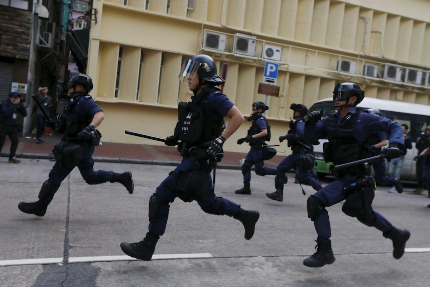 Hong Kong police running during riot