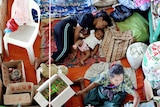 An East Timorese family rests at a makeshift refugee camp in Dili.