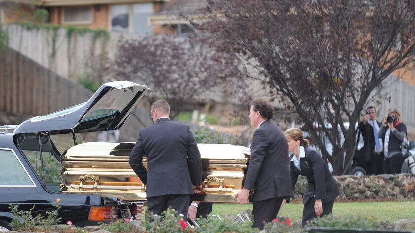 Carl William's coffin is unloaded