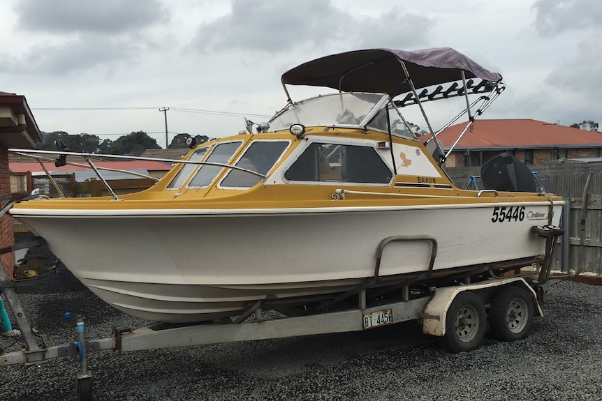 A 17 foot yellow and white Caribbean half cab boat