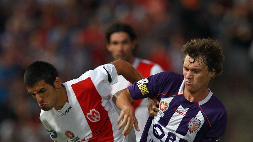 Tight clash ... Tommy Amphlett of the Glory and Aziz Behich of the Heart battle for possession.